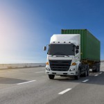 White Truck on highway road with green  container, transportation concept.,import,export logistic industrial Transporting Land transport on the asphalt expressway with blue sky